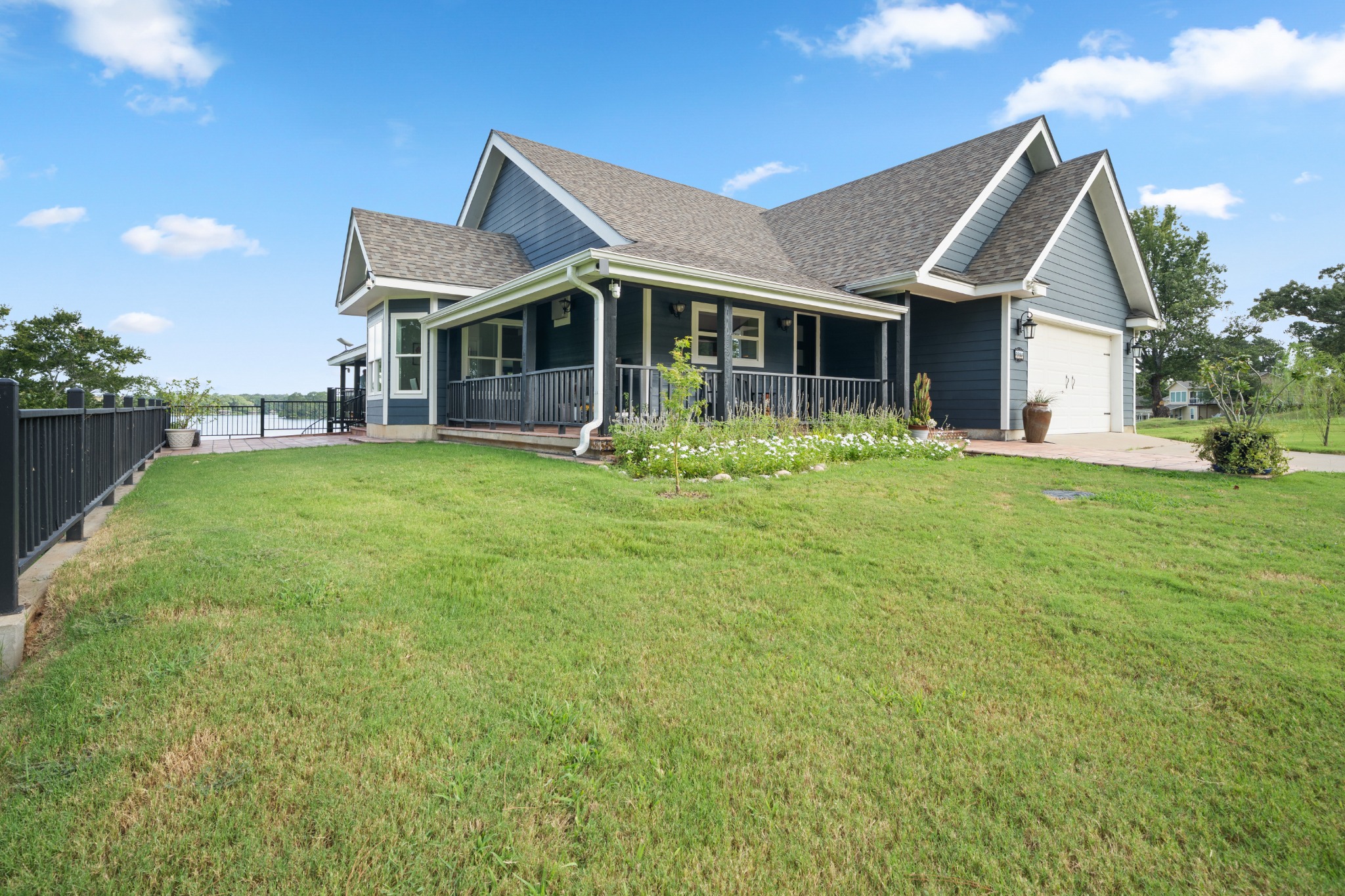 Blue waterfront home with wraparound porch