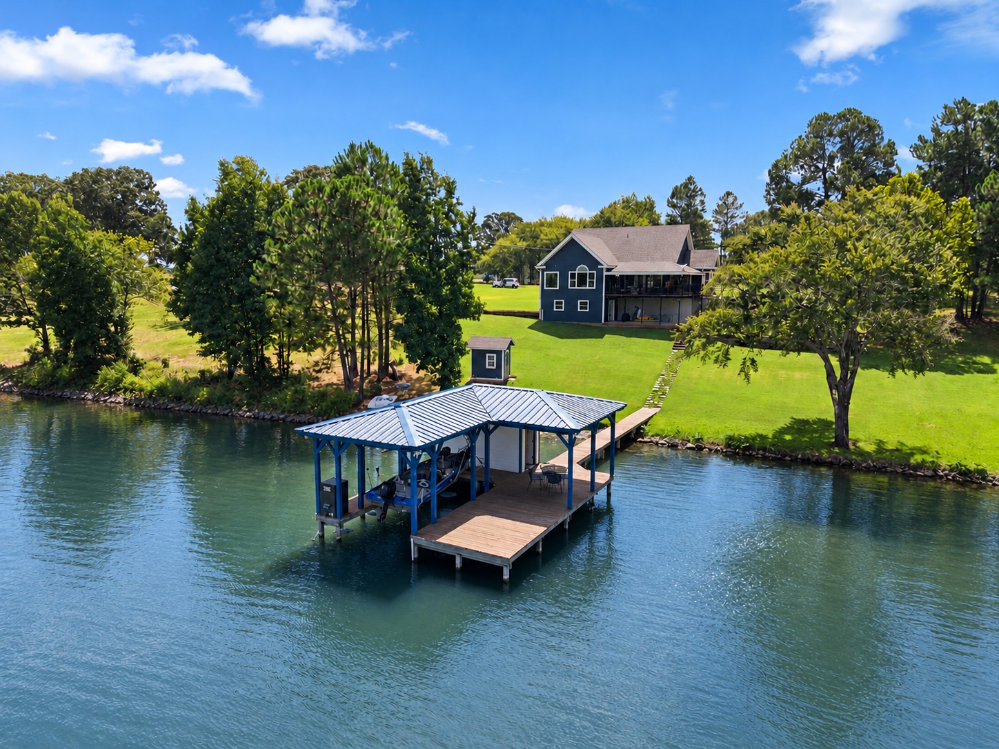 Lakefront home and covered boathouse at 7581 E Lake Drive