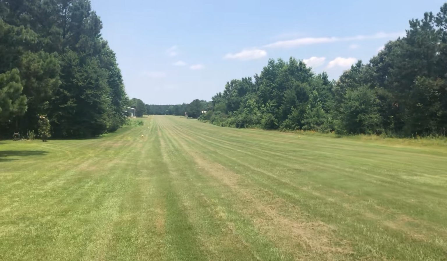 View along the maintained Bermuda grass runway at Aero Estates Airpark