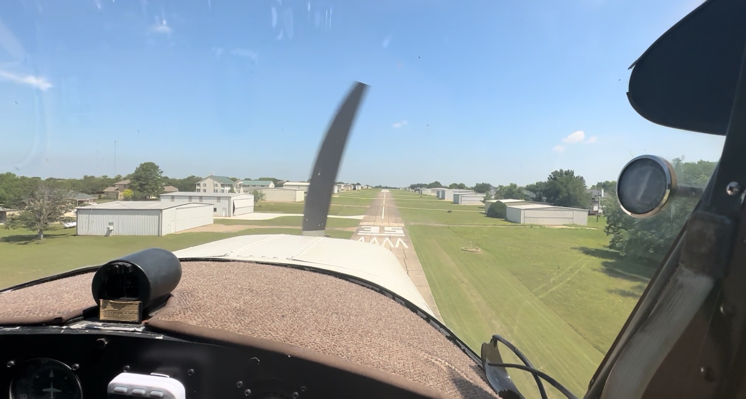 Pilot’s view on short final to Runway 35 at Eagle’s Nest Estates Airport with hangars on both sides