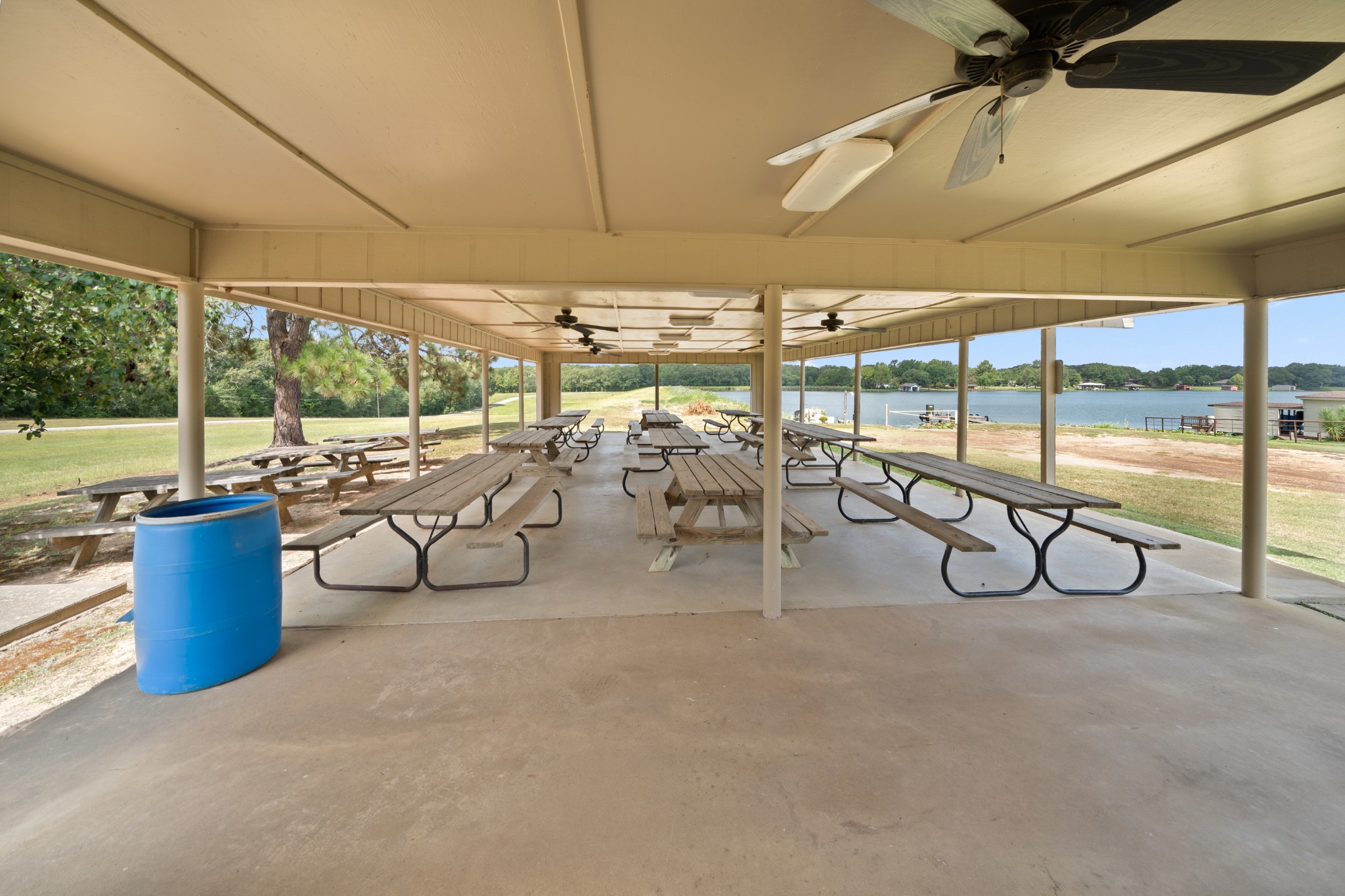 Covered outdoor community pavilion with picnic tables overlooking Echo Lake