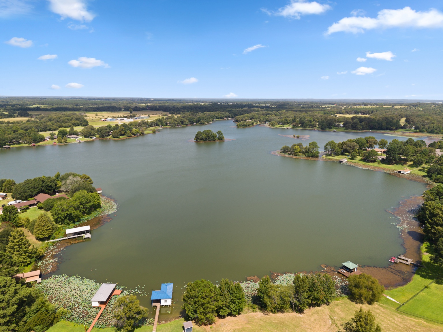 Wide aerial view of Echo Lake with waterfront homes, docks and a small island