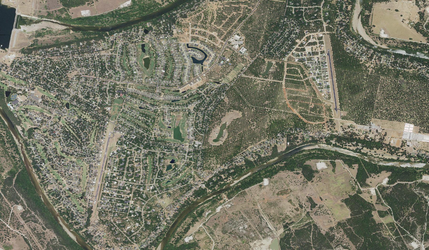 Aerial view of Pecan Plantation showing the Brazos River, Pecan Plantation Airport (0TX1), and The Landings (66TE)